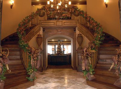 The foyer is a breathtaking picture of golden banisters and glittered feathers.