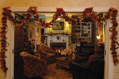 Homemade pinecones and ribbon garland frame the entryway to the front parlor. (Mike Kemp photos)
