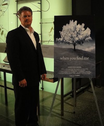 Kelly Shipp with the movie poster that features his winning photo. The short film – titled “when you find me” – will be available for viewing online Dec. 16-19 at youtube.com/imagination.