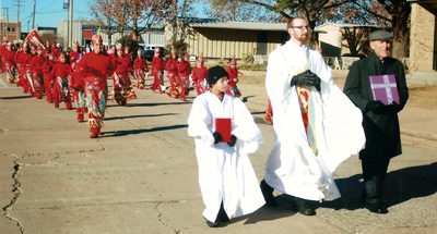 Associate pastor  Father James Melnick of St. Joseph Church leads this part of the procession last year along with Deacon Richard Papini and altar server Benjamin Rios. (Ray Nielsen photo)