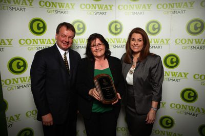 At last year’s chamber meeting, Debbie Plopper (center) was presented the Distinguished Service Award. She is pictured with Conway Mayor Tab Townsell (left) and Lori Ross, chamber board chairman.