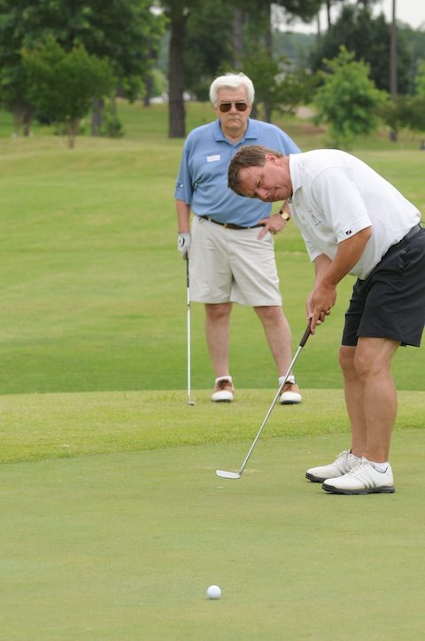 Conway Mayor Tab Townsell lines up a putt.