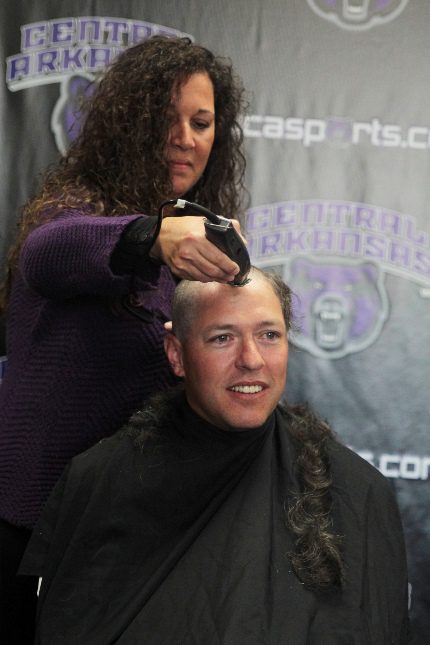 UCA athletic director Brad Teague gets his hair cut to support UCA athletics' administrative assistant Milisa Moore, who is undergoing chemotherapy to battle breast cancer.