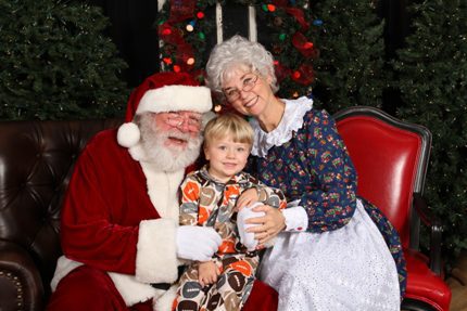 Weston Spears enjoys visiting with Santa and Mrs. Claus at last year’s Pajama Party. (Donna Evans photo)