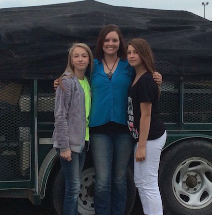 Jennifer Rodman from Conway Recycling with Emily Jordan and Brianna Branch in front of the trailer filled with electronic waste collected at the GMS Earth Day.