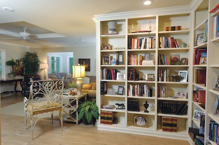 What once was a very small opening into the family room is now a beautiful entrance that showcases memorabilia, books and family photographs.