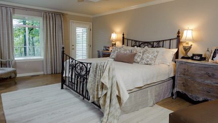 In the master bedroom, Terry used a very neutral but warm pallet. This accentuates the magnificent iron bed and doesn't detract from the lovely views outside.