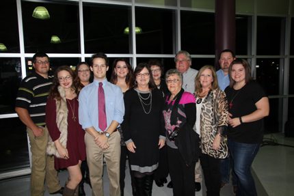 Regina Erwin (center) was named the Educator of the Year by the Morrilton Area Chamber of Commerce. Family and friends attending the event included Sydney Smith (front, from left), Dylan Erwin, Regina Erwin, Helen Ward, Teresa Stell, Kaitlyn Stell; Jonathan Franklin (back), Jessica Franklin, Courtney Stell, Paula Franklin, Garry Franklin and Cody Stell.