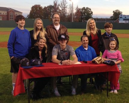 Those attending the signing ceremony for Collin Cahill (seated, center) included his parents (seated), Mary Jane (Cahill) Pettit and Doug Cahill; Carson Cahill (back, from left), Jill Pettit, Joel Pettit, Amy Cahill, James Buckner and Sophie Cahill.