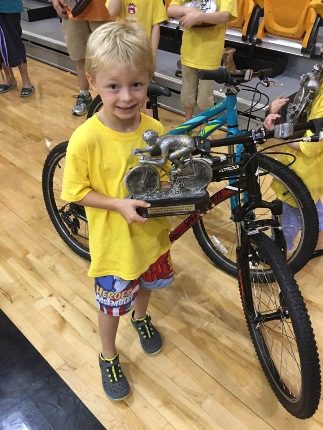 Hayes McClurkin poses with his trophy after the race. Hayes also won a bike from “The Ride” when his name was drawn for a door prize.