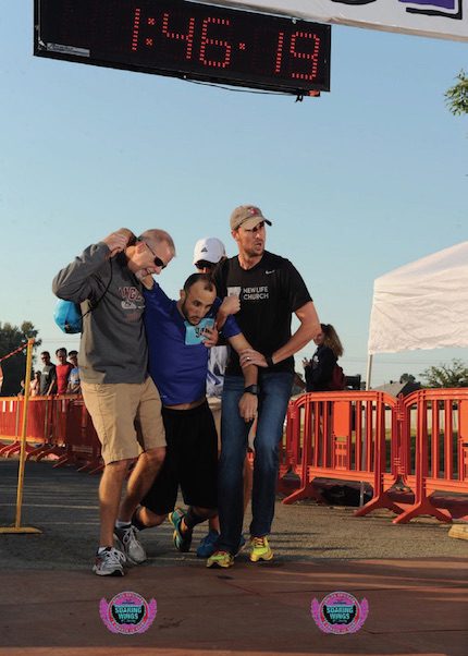 Darren Mathews of Searcy (left) and Ben Gipson help Joey Smith at the finish line of the Soaring Wings Half Marathon. Darren did not know Joey but found him on Facebook and let him know he was praying for his recovery. (Photo courtesy of Run Bike Swim Photos/ runbikeswimphotos.com)